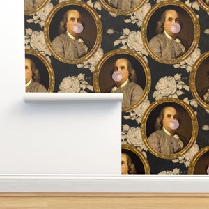 May include: A repeating pattern wallpaper featuring a portrait of a man with a large bubble of pink bubble gum in his mouth. The portrait is framed in gold and set against a black background with white roses.