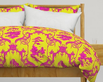 May include: A yellow duvet cover with a pink floral pattern. The duvet cover is on a bed with white pillows and a wooden headboard.
