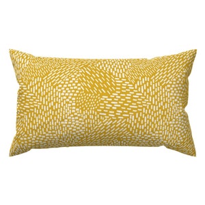 May include: A yellow throw pillow with a white geometric pattern.