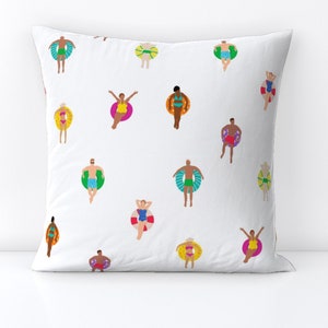 May include: White pillowcase featuring a colourful pattern of people floating on inflatable rings. The people are wearing swimsuits and are in various poses. The background is white.