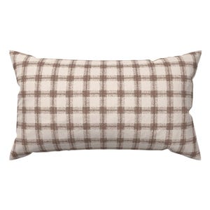 May include: Rectangular decorative pillow with a brown plaid pattern on a cream background. The pillow has a soft, textured appearance, with a classic farmhouse style. The pillow is designed for home decor.