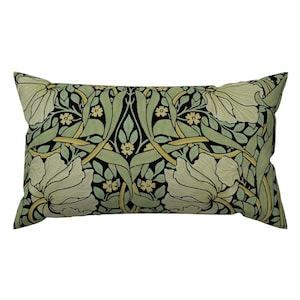 May include: A rectangular pillow with a black background and a floral pattern in shades of green and yellow. The pattern features stylized flowers and leaves.