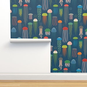 May include: A seamless pattern wallpaper featuring colorful jellyfish on a dark blue background. The jellyfish are of various sizes and shapes, with different colored tentacles and bells.