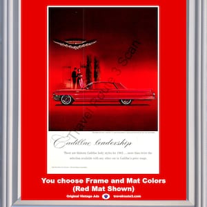 May include: Framed vintage Cadillac advertisement. The image features a red Cadillac car with a couple standing nearby. The text reads "Cadillac leadership" and "You choose Frame and Mat Colors (Red Mat Shown)".