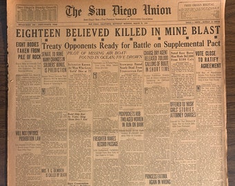 May include: A vintage newspaper, "The San Diego Union," with headlines about a mine blast, a missing air boat, and prohibition. The paper is aged with visible creases and wear, showcasing its historical context.