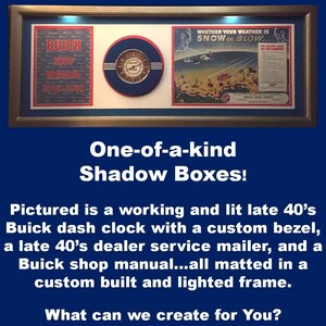 May include: A framed shadow box featuring a vintage Buick dash clock, a shop manual, and a service mailer. The clock has a custom bezel. The frame includes the text "We can also make You:" and "One-of-a-kind Shadow Boxes!"