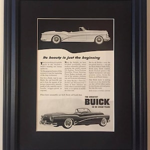 May include: Framed vintage advertisement for Buick cars. The black and white print features two classic convertible models, with text describing the cars' features and the Buick brand. The frame is black.