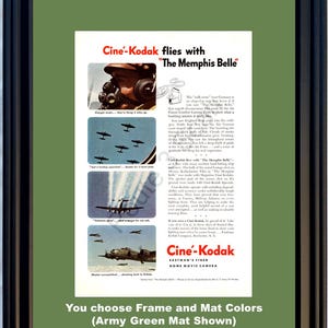 Op de afbeelding: Ingelijste vintage advertentie voor Cine-Kodak-thuisfilmcamera's, met afbeeldingen van vliegtuigen en tekst. De advertentie is geplaatst tegen een legergroene passe-partout, met een zwart frame. De tekst luidt "Cine-Kodak flies with 'The Memphis Belle'" en "Eastman's Finer Home Movie Camera."