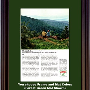 May include: Framed vintage advertisement for Shenandoah National Park, showing a mountain scene with two figures. The ad text discusses conservation and the New York World's Fair, presented with a forest green mat and a dark brown frame.