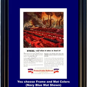 May include: Framed vintage advertisement for Pennsylvania Railroad, featuring a colorful illustration of red train cars and industrial buildings. The ad text reads "STEEL - and what it takes to haul it!" with additional text. The frame and mat are navy blue.