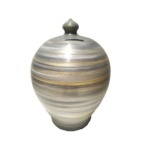 May include: A ceramic money box with a swirl design in shades of grey and gold.