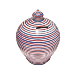 May include: A white ceramic money box with red and blue stripes. The money box has a round body and a small lid on top.