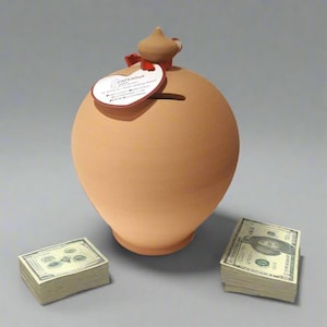 May include: A terracotta-coloured piggy bank with a rounded body and a small, pointed top. A red ribbon and a tag with the text "CATERINA" are attached. Two stacks of US dollar bills are placed near the bank.