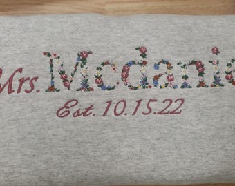Braut-Sweatshirt mit Blumen- und Buchstabenstickerei, personalisiertes „Mrs.“-Sweatshirt mit Datum, florales Hochzeits-Sweatshirt, Geschenk zum Junggesellinnenabschied
