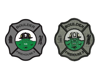 May include: Two embroidered patches, one in grey and one in green, with a grey background and black outlines. Both patches feature a stylised image of a green Hulk wearing a firefighter's helmet with the number 3 on it. The text "BOULDER FIREHOUSE 3" is on both patches.