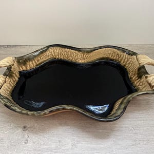 May include: A set of three ceramic nesting bowls in graduating sizes. The bowls are white with a speckled, textured finish and feature a slightly flared rim. The largest bowl measures approximately 8 inches in diameter.