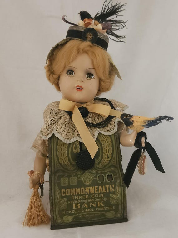 Altered Antique Doll  Assemblage On Metal Nouveau Design Bank ,Her Name Is FLORA DORA