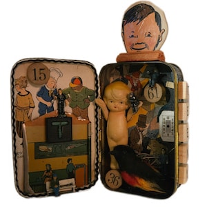 May include: A mixed-media assemblage art piece featuring two open metal tins. The left tin displays a vintage illustration with the number 15, a letter T block, and miniature figures. The right tin contains a small doll, a bird, and the number 61.