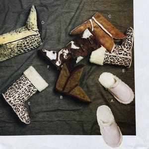 May include: A collection of footwear including two leopard print boots with white fleece lining, one brown suede boot, one cow print boot with brown leather straps, one tall leopard print boot, and two light pink slippers with white fleece lining.