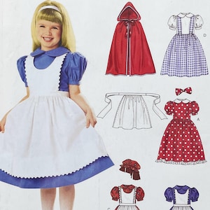 Könnte beinhalten: Ein Schnittmusterumschlag mit einem blauen Kleid mit weißer Schürze, einem roten Kapuzenumhang, einem lila karierten Kleid mit weißer Bluse, einem roten gepunkteten Kleid mit passender Schleife und einer weißen Schürze. Abbildungen zeigen verschiedene Designs.