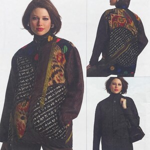 May include: A dark-toned jacket featuring a high collar and long sleeves. The garment displays a mix of panels with black fabric, sections with white calligraphic text, and vibrant ikat-style patterns in red, yellow, and blue hues.