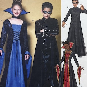 May include: A sewing pattern envelope featuring costumes including a long black and blue dress with a high collar and lace-up bodice, and a long black coat with a high neck. The pattern also shows a black and red dress with a high collar.