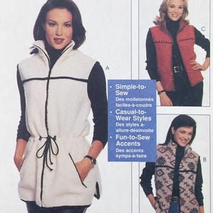 May include: A sewing pattern envelope featuring three sleeveless vests. Style A is a long white fleece vest with black trim and a drawstring waist. Style B is a patterned fleece vest. Style C is a red fleece vest with visible black blanket stitching.