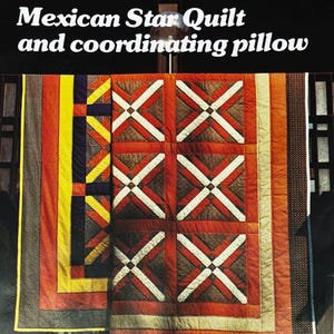 May include: A colorful quilt and coordinating pillow with the text "Mexican Star Quilt and coordinating pillow". The quilt features a geometric design with red, white, and brown accents. The quilt has a variety of colors including yellow, orange, and navy blue.