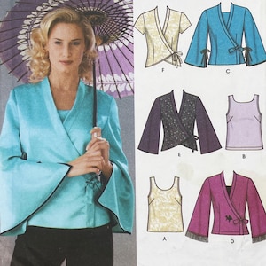 May include: A sewing pattern envelope featuring a light blue wrap jacket with wide sleeves and a tie closure. The illustration displays various garment options including wrap jackets with different sleeve lengths, patterns, and tank tops labeled A through F.