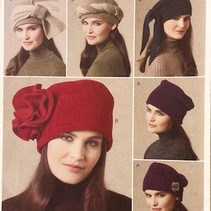 May include: A collection of sewing pattern illustrations featuring various hat styles including a red hat with a large fabric flower, a black hat with long side ties, a purple hat with a decorative pin, and two neutral-toned hats with draped details.