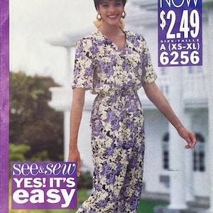 May include: A sewing pattern envelope for a short-sleeved jumpsuit with a V-neckline and an elasticated waist. The garment features a floral print in shades of purple, white, and green. Text on the cover includes "see & sew YES! IT'S easy" and "6256".