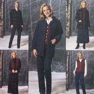 May include: A collection of clothing featuring a dark blue jacket, a matching pair of trousers, a burgundy button-up vest, a white collared shirt, a dark turtleneck, a long dark skirt, and a dark plaid jacket, all displayed in a winter forest setting.