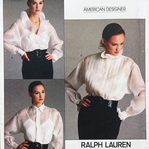 May include: A sewing pattern envelope titled AMERICAN DESIGNER RALPH LAUREN featuring three variations of a white sheer long-sleeved blouse. The designs include a ruffled collar, a pleated front, and a classic button-down style with a collar.