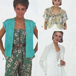 May include: Three vintage women's fashion designs are shown. The first is a teal short-sleeved jacket over a floral jumpsuit. The second is a floral print cape-like top. The third is a white jacket with lace trim.