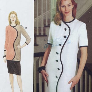 May include: A sewing pattern illustration showing two dress variations. Variation B features a peach and tan colour-blocked tunic with black trim and a black skirt. Variation A is a white dress with short sleeves, black trim, and a curved button placket.