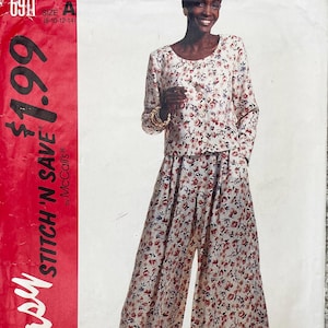 May include: A two-piece floral print outfit. The top has long sleeves and a round neckline. The wide-leg trousers and top feature a cream background with red and pink floral patterns. The image also shows a McCall's pattern.