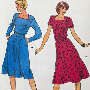 May include: A sewing pattern illustration featuring two dress styles. Style A is a solid blue long-sleeved dress with a square neckline. Style B is a short-sleeved red dress with a black floral print and a square neckline. Both dresses feature elasticized waists.