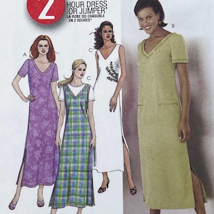 May include: A sewing pattern envelope featuring the text 2 HOUR DRESS OR JUMPER. The illustration displays four variations of floor-length dresses: a purple floral print, a green and blue plaid jumper over a white shirt, a white dress, and a solid olive green dress.