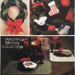 May include: A collection of holiday-themed fabric items including a braided wreath with a red bow, Christmas stockings, and bird ornaments. The lower section displays placemats with green holly patterns and white napkins with red bows, labelled TAPESTRY PATTERN COLLECTION.