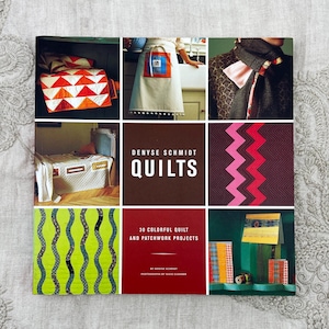 May include: A collage of images featuring quilts and patchwork projects. The central image is a book cover titled "Denyse Schmidt Quilts." Other images showcase quilts with geometric patterns, an apron, and a bed with a quilt. The book cover also says "30 Colorful Quilt and Patchwork Projects."