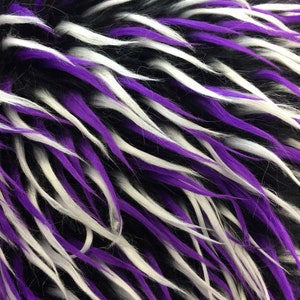 May include: Black, white, and purple faux fur fabric with long, shaggy strands.