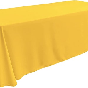 May include: A bright yellow rectangular tablecloth. The tablecloth is made of a smooth, wrinkle-resistant fabric.