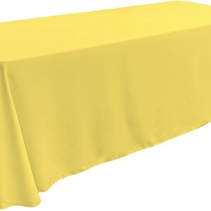 May include: A bright yellow rectangular tablecloth. The tablecloth is made of a smooth, wrinkle-resistant fabric.
