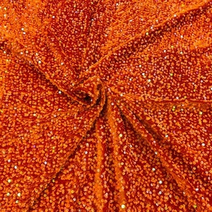 Iridescent Shiny Sequins on a 2 Way Stretch Velvet. Sold by Yard. Orange