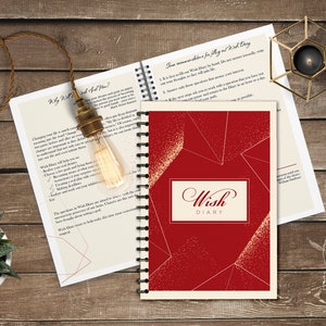 May include: Red Wish Diary with gold accents and a white background. The cover features a geometric design with a gold outline. The words "Wish Diary" are printed in a gold script font.