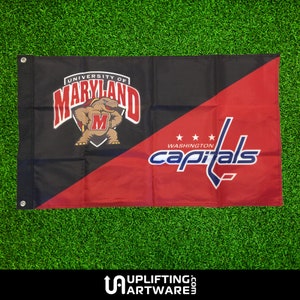 May include: A black and red flag with the University of Maryland Terrapins logo on one side and the Washington Capitals NHL team logo on the other side.