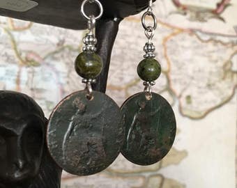 May include: Silver earrings with green stone beads and antique copper coin-shaped pendants.