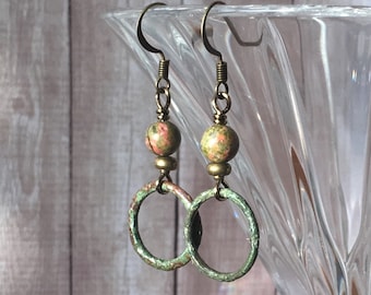 May include: A pair of earrings with green and brown jasper stone beads and antique brass hoops.