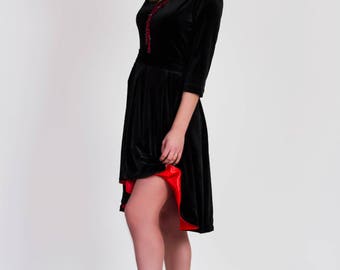 Black velvet wedding guest asymmetrical dress with flared skirt and red lining