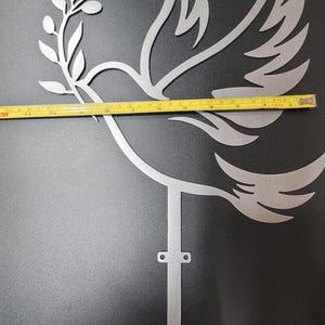 Crafted from sturdy silver-toned metal, this dove tree topper is built to last through countless holiday seasons without bending or tarnishing. Its durable design ensures it remains a cherished part of your festive decor, whether displayed on the tree or repurposed as symbolic wall art year-round.